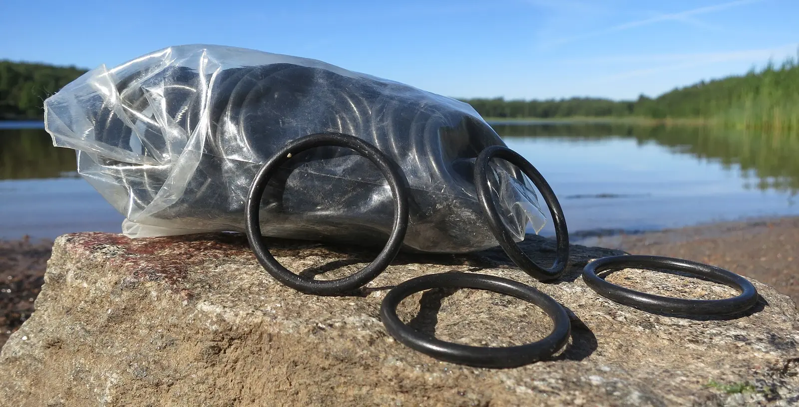 Black nitrile O-rings stacked in front of a bag of spares
