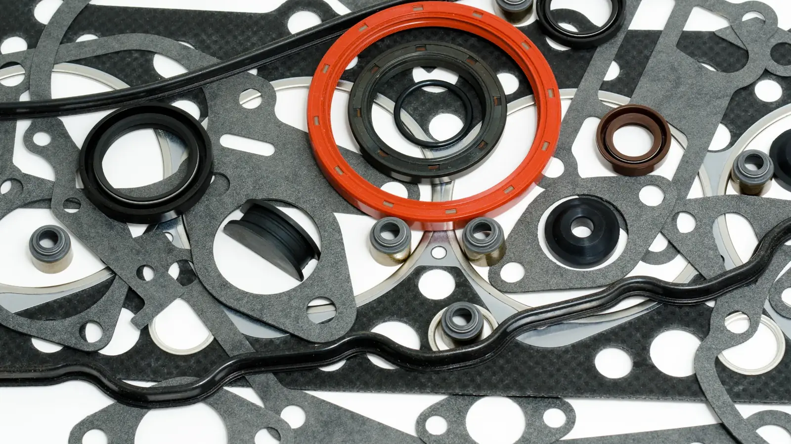 Assorted rubber oil seals and cut gaskets laid out together
